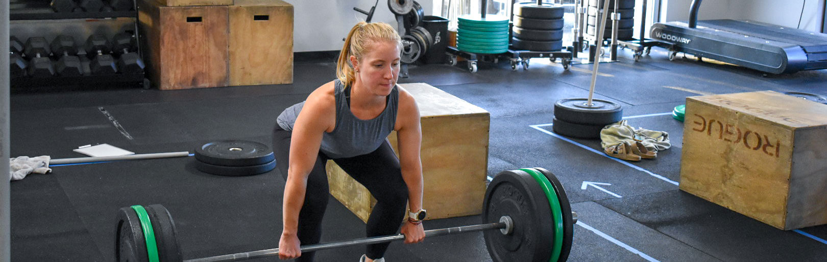 Female member deadlifts at CrossFit Alaska.