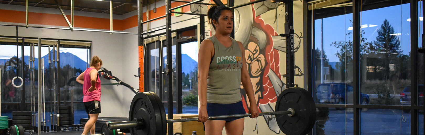 Female member deadlifts at CrossFit Alaska.