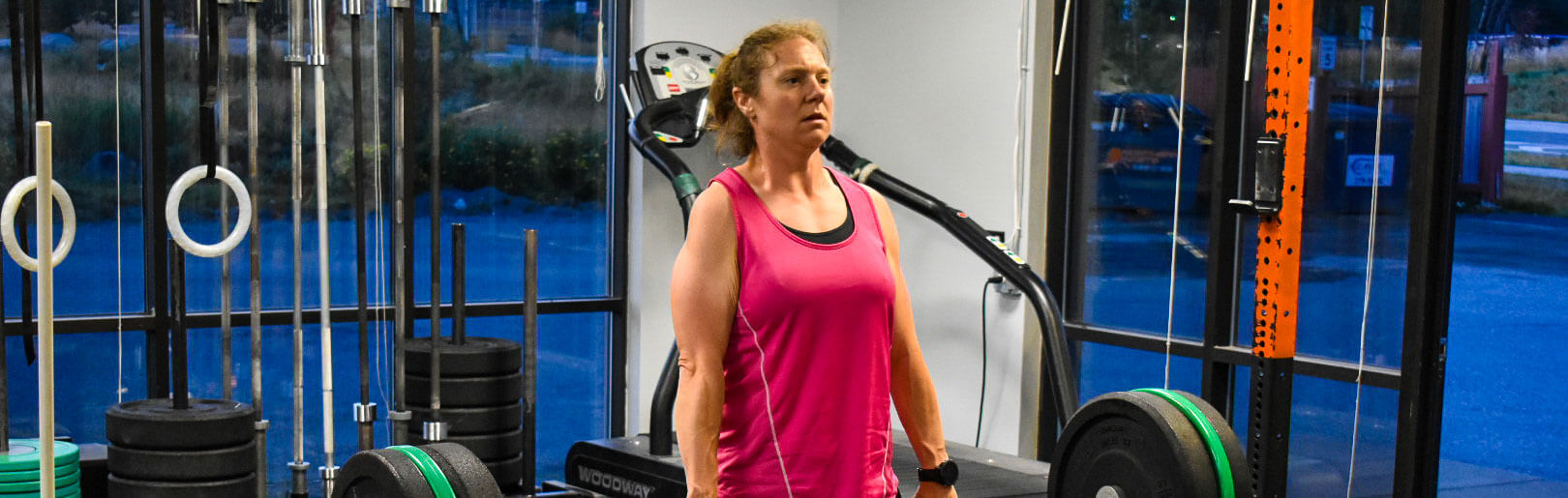 Female member deadlifts at CrossFit Alaska.