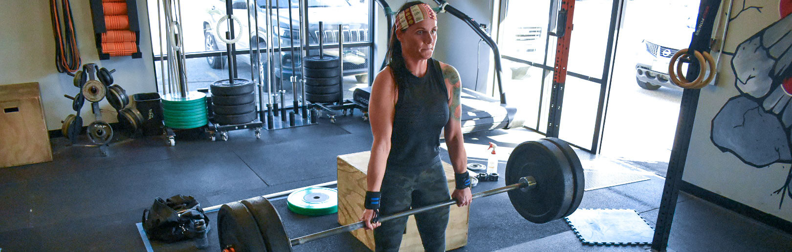 A female member deadlifts at CrossFit Alaska.